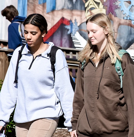 2 female studetns walking outside