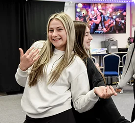 Girls playing air guitar